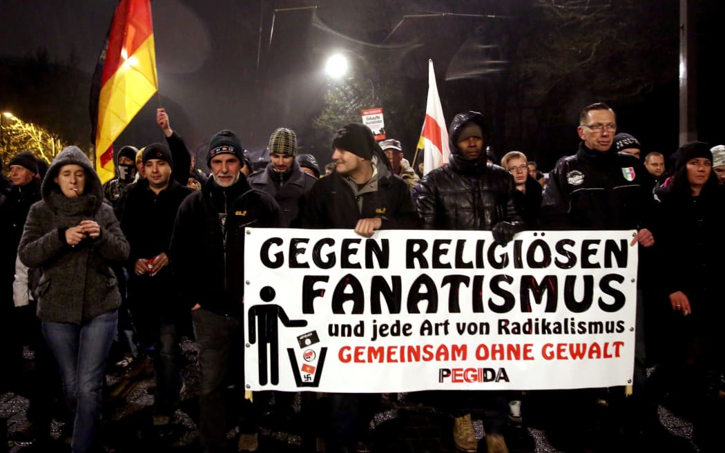 Supporters of the Pegida movement (Patriotic Europeans Against the Islamisation of the Occident) gather for another of their weekly protests in Dresden, Germany.