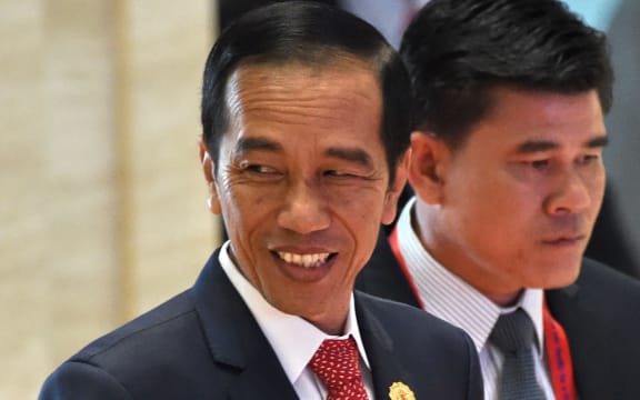 Indonesia's President Joko Widodo (L) arrives at the Association of Southeast Asian Nations (ASEAN) Summit in Vientiane on September 7, 2016.
