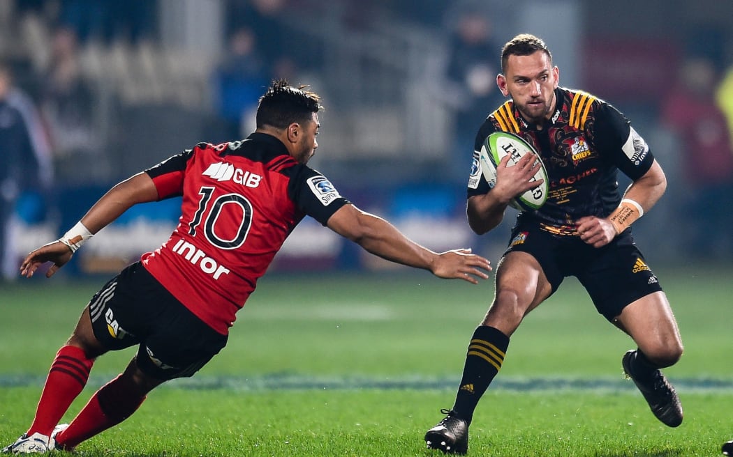 Aaron Cruden of the Chiefs eludes Richie Mo'unga during the first Super Rugby final.