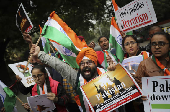 A National Akali Dal leader shouts slogans in support of India and against Pakistan as he celebrates reports of Indian aircrafts bombing Pakistan territory, in New Delhi, India.