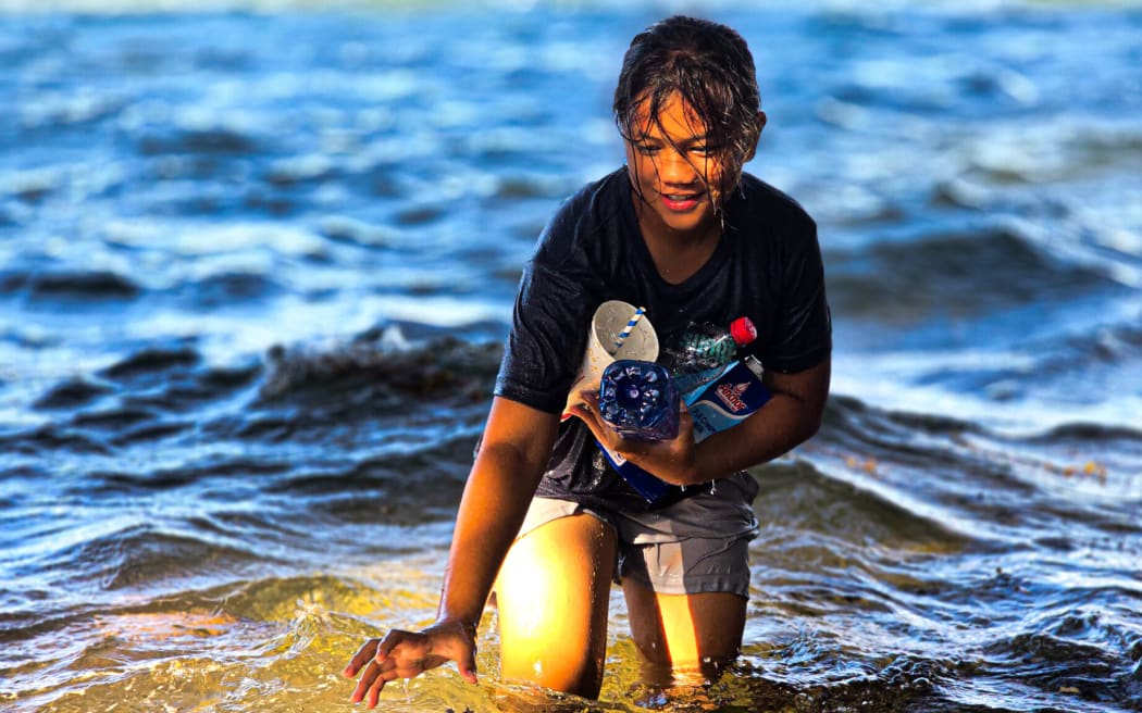 Winning entry in the 15-16 year olds category of the Our Climate, Our Future photography competition. Girl collecting plastic waste taken at Mulinuu, Samoa 2024