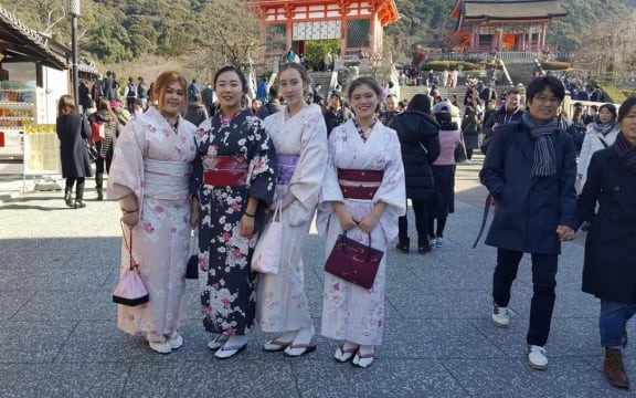 Four people wearing kimonos.