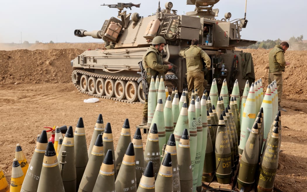 Artillery shells are lined up next to an armoured vehicle as Israeli soldiers take positions near the border with Gaza in southern Israel on October 9, 2023. Stunned by the unprecedented assault on its territory, a grieving Israel has counted over 700 dead and launched a withering barrage of strikes on Gaza that have raised the death toll there to 493 according to Palestinian officials.
