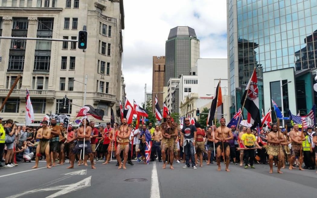 Protesters arrive at the bottom of Queen St after marching