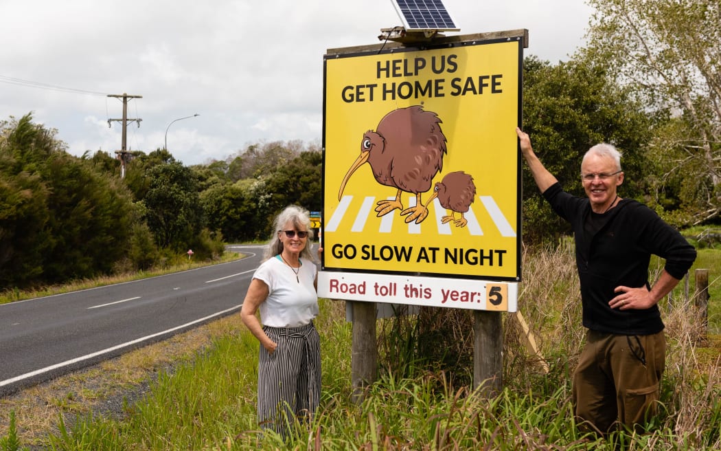 Deb Bayens-Wright and Dean Wright with one of the billboards Kerikeri Peninsula Conservation Charitable Trust has put up around Rangitane.