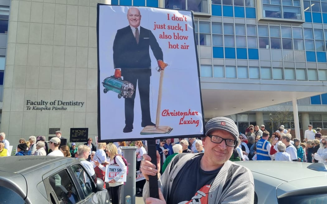 One of the estimated 35,000 people who protested in Dunedin against possible cuts to the new hospital.