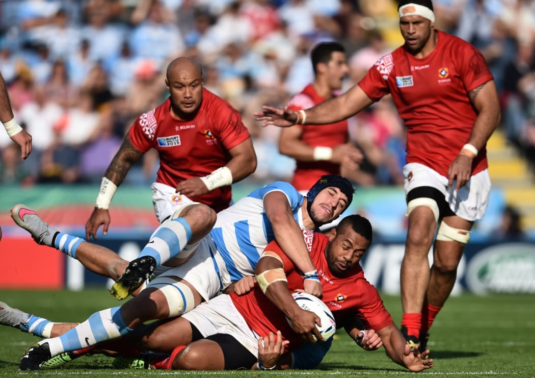 Elvis Taione is tackled during the 2015 Rugby World Cup between Argentina and Tonga