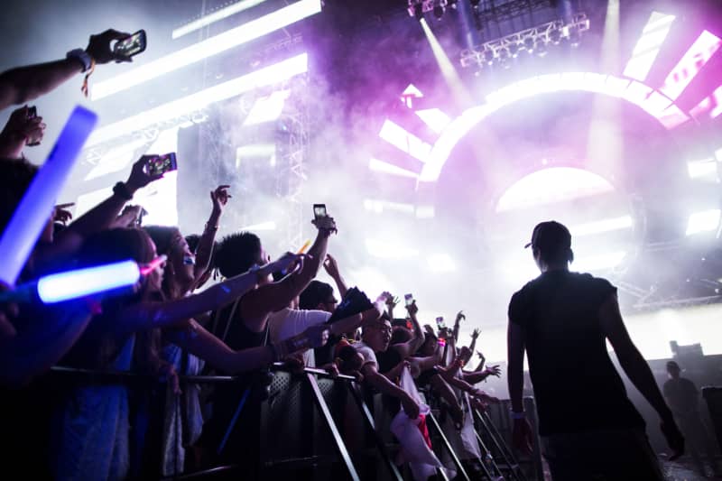 Japanese attend an electronic music concert during the Japan Ultra Music Festival at Odaiba Ultra Park in Tokyo on September 18, 2016.