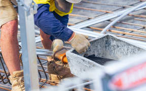 A person in protective gear working on a construction site.