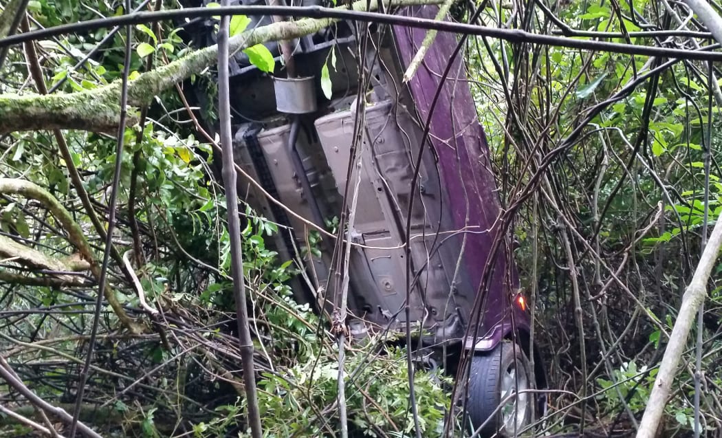 The car was found 100 metres down a bank on Piha Road