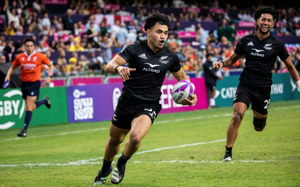 New Zealand’s Xavier Tito-Harris (L) scores a try against the USA during their match on the second day at the Hong Kong Sevens.