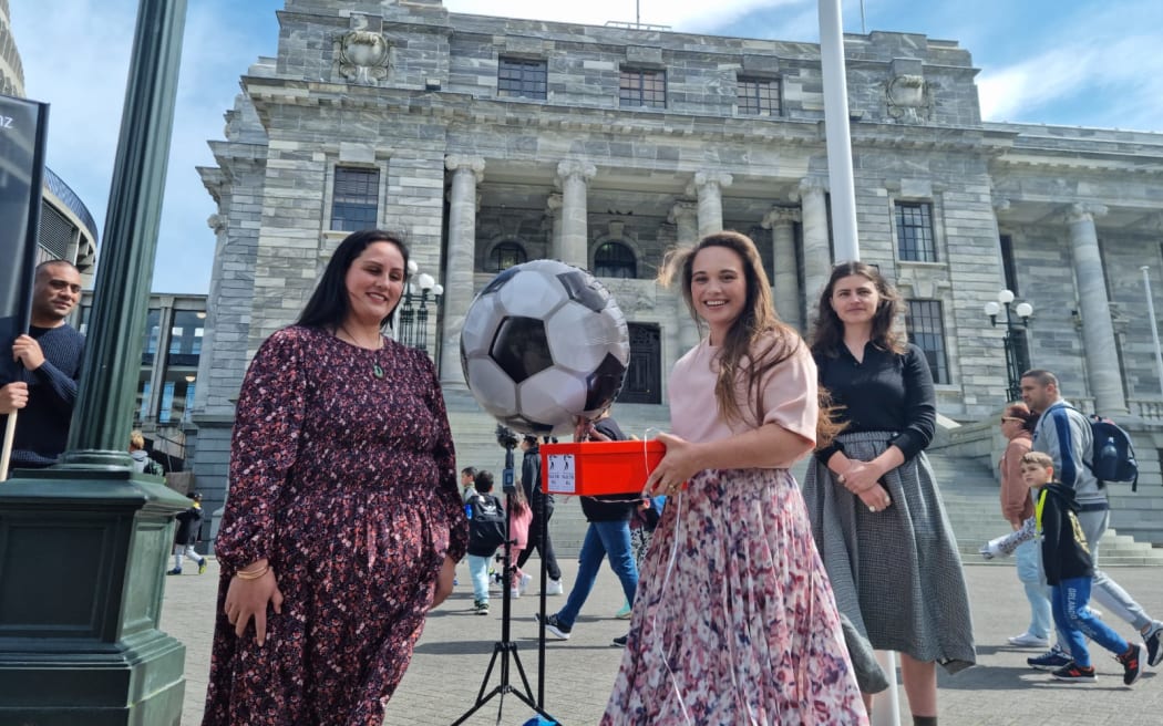 Labour MP for Manurewa Arena Williams at Parliament receives a petition from Alcohol Health Watch and Hapai te Hauora in support of Chloe Swarbrick's member's bill to reduce alcohol harm in communities.