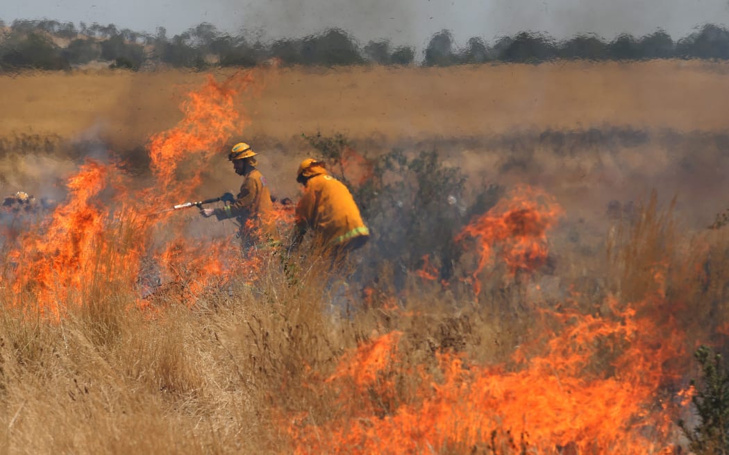 A grass fire close to homes in the Melbourne suburb of Craigieburn.