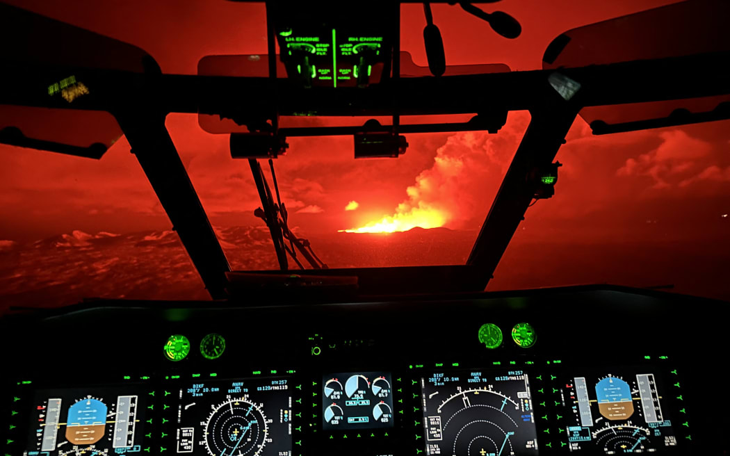 This handout picture released by the Icelandic Coast Guard on March 16, 2024 shows billowing smoke and flowing lava pouring out of a new fissure, seen from the helicopter cockpit during a new volcanic eruption on the outskirts of the evacuated town of Grindavik, western Iceland. A volcanic eruption started on the Reykjanes peninsula in southwestern Iceland on Thursday, the third to hit the area since December, authorities said. (Photo by HANDOUT / Icelandic Coast Guard / AFP) / RESTRICTED TO EDITORIAL USE - MANDATORY CREDIT "AFP PHOTO /HANDOUT/ICELANDIC COAST GUARD " - NO MARKETING - NO ADVERTISING CAMPAIGNS - DISTRIBUTED AS A SERVICE TO CLIENTS