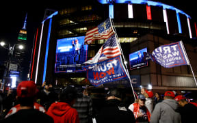 Donald Trump supporters wait outside Madison Square Garden where former US President and Republican presidential candidate Donald Trump holds a campaign rally in New York, October 27, 2024. (Photo by Leonardo Munoz / AFP)