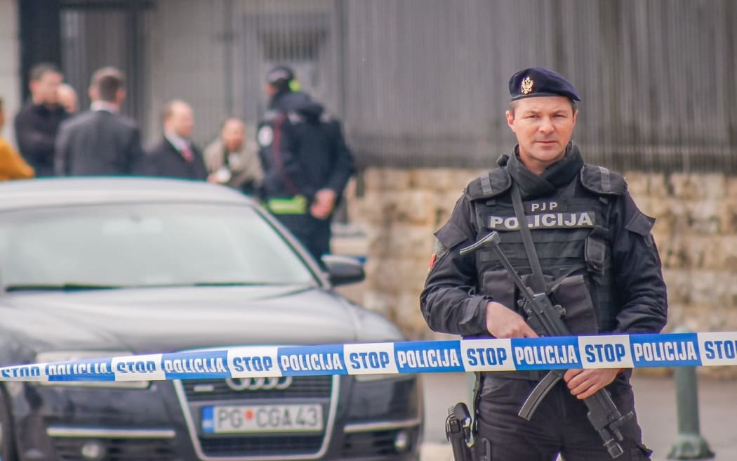 Police guard the site where an explosive device was thrown at the US embassy in Podgorica, Montenegro.