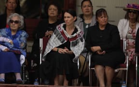 Prime Minister Jacinda Ardern sitting alongside Titewhai Harawira (left) at the Waitangi Treaty grounds (4 February, 2020).