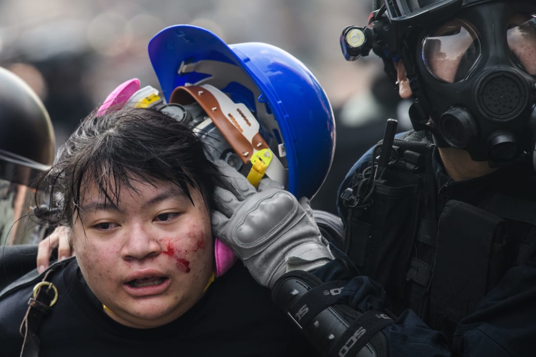 Police detain a protester during an attempt to escape the campus of the Hong Kong Polytechnic University in the Hung Hom district of Hong Kong.