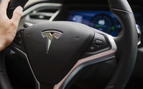 A man drives his Tesla Model S electric car in Wuhan in central Chinese province Hubei (file).