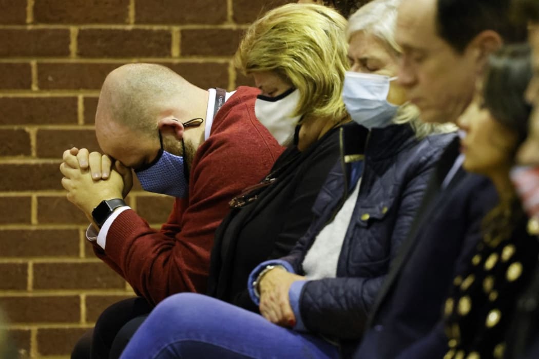 A man prays as people attend a mass in memory of Conservative British lawmaker David Amess, who was fatally stabbed, at Saint Peter's Catholic Parish of Eastwood in Leigh-on-Sea, a district of Southend-on-Sea, in southeast England on October 15, 2021.
