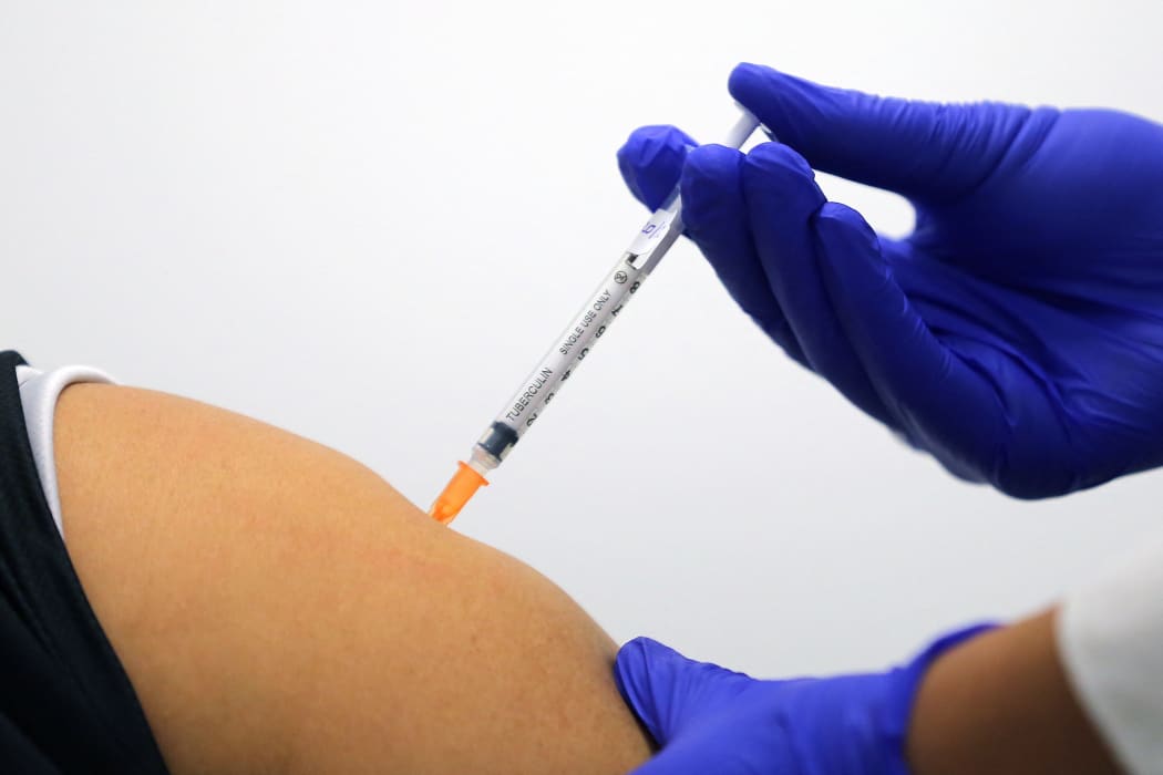 A woman receives a dose of the Pfizer/BioNTech Covid-19 vaccine during the first rollout in Australia at the Castle Hill Medical Centre in Sydney on February 21, 2021.