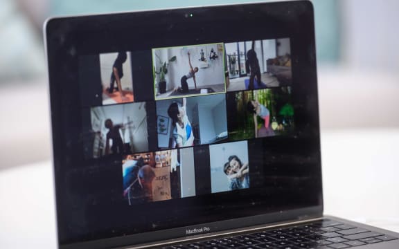 In this picture taken on March 30, 2020, YogaUP founder Chaukei Ngai (top C) is seen leading a group of students via the Zoom online video conferencing platform, during a live streamed yoga class at her studio in Hong Kong.