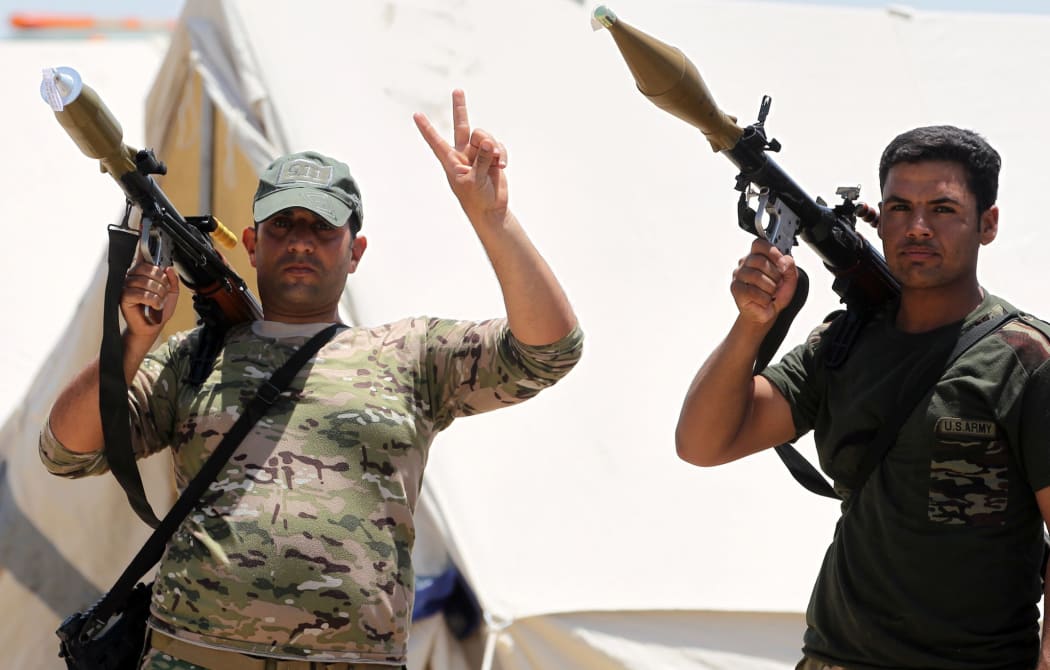 Members of the Iraqi security forces mounts a gun atop a vehicle as they gather on the outskirts of Fallujah as they prepare an operation aimed at retaking the city from the Islamic State (IS) group, on May 22, 2016.