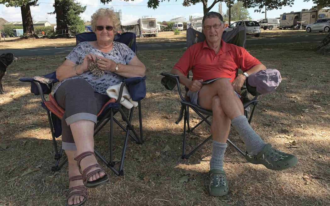 Julia Jermyn and Ian Sutton wait at the Richmond A&P showgrounds with their three dogs and cat.