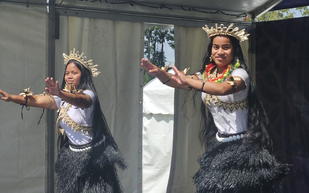 A young Kiribati duo graces the stage, sharing their traditional dance forms with a crowd of thousands.