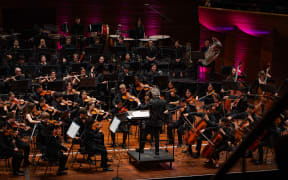 NZSO National Youth Orchestra with conductor Adam Johnson onstage at Wellington's Michael Fowler Centre.
