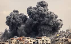 A plume of smoke rises in the sky of Gaza City during an Israeli airstrike on October 9, 2023. Israel relentlessly pounded the Gaza Strip overnight and into October 9 as fighting with Hamas continued around the Gaza Strip, as the death toll from the war against the Palestinian militants surged above 1,100.