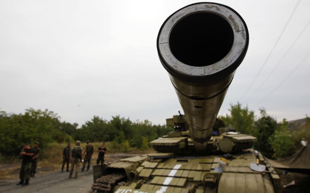 A Ukrainian army tank is pictured at a checkpoint in Donetsk region 22 August.