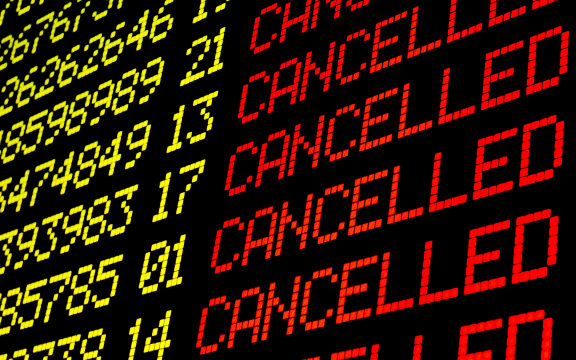 Cancelled flights on airport board panel