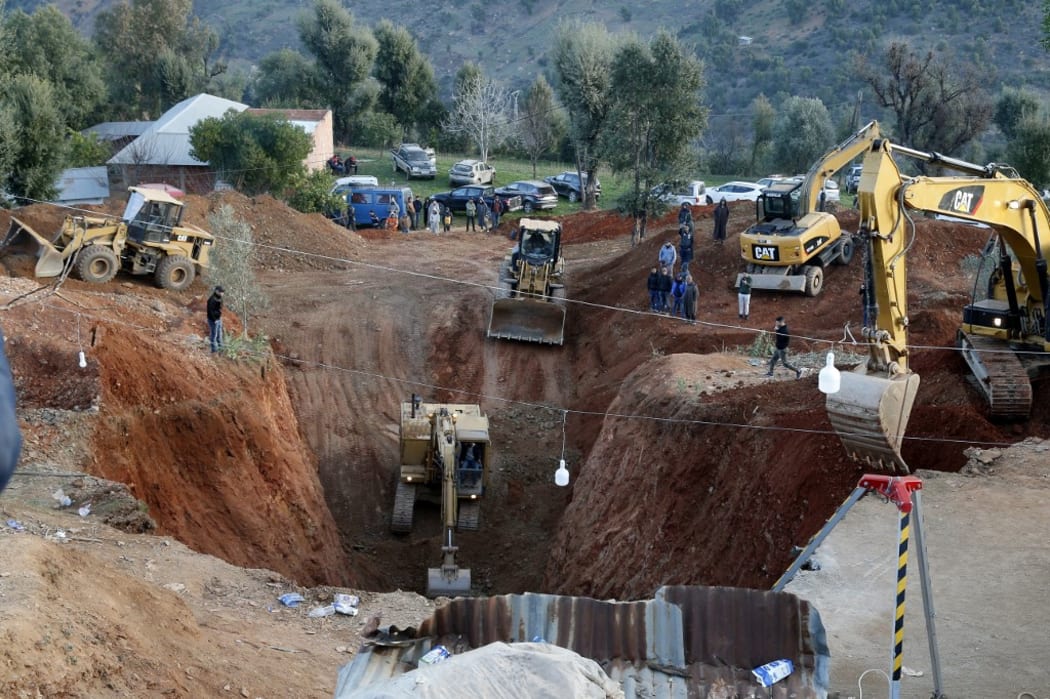 Moroccan authorities and firefighters work to get five-year-old child Rayan out of a well.