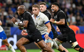 All Blacks winger Mark Telea makes a break against Italy.