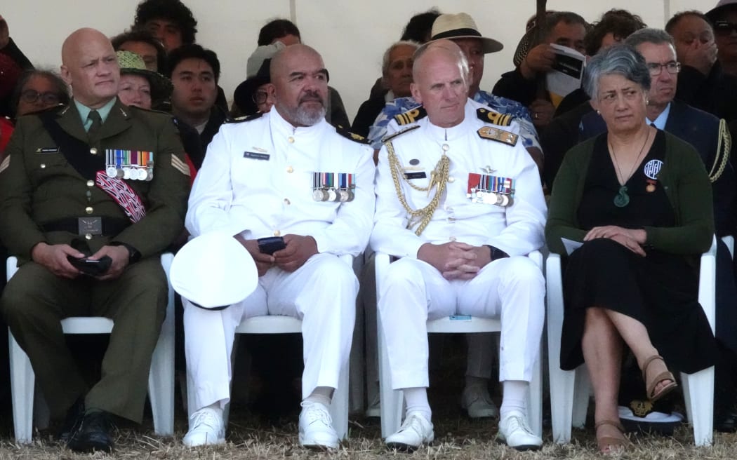 Rear Admiral Mat Williams, Defence Force deputy chief, third from left, listens to the service.