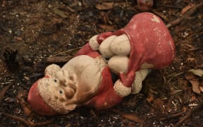 A scorched santa toy is seen on property razed by bushfires in Bargo, southwest of Sydney, on December 21, 2019.