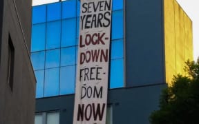 One of the banners unfurled by protesters at the Mantra Hotel in Melbourne.