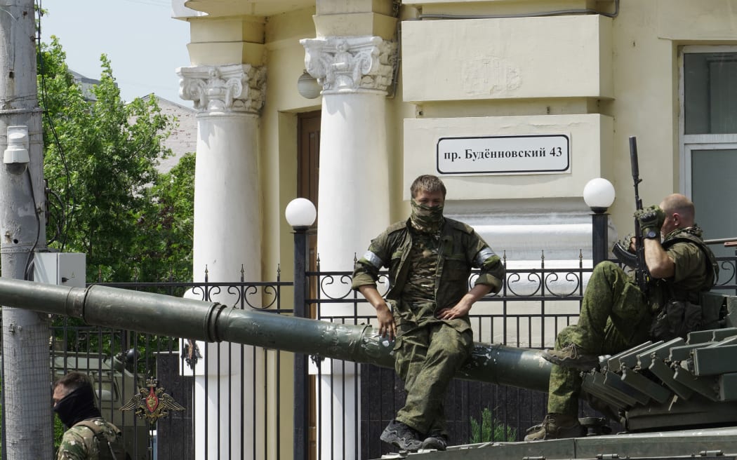 Members of Wagner group sit atop of a tank in a street in the city of Rostov-on-Don, on June 24, 2023. President Vladimir Putin on June 24, 2023 said an armed mutiny by Wagner mercenaries was a "stab in the back" and that the group's chief Yevgeny Prigozhin had betrayed Russia, as he vowed to punish the dissidents. Prigozhin said his fighters control key military sites in the southern city of Rostov-on-Don. (Photo by STRINGER / AFP)