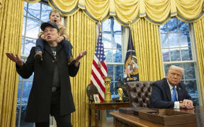 Tesla and SpaceX CEO Elon Musk with his son X Æ A-Xii join US President Donald Trump as he signs executive orders in the Oval Office of the White House in Washington, DC, 11 February 2025.