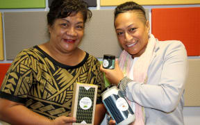 Two of the Directors of Maiden South Pacific, Kalala Mary Autagavaia (L) and Tiana Epati holding their organic coconut oil and breadfruit flour products.
