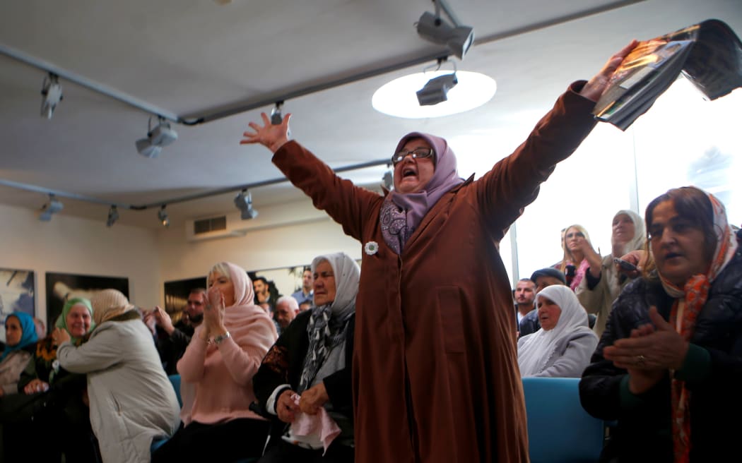 Relatives of Srebrenica victims of crimes, committed during the 1992-1995 Bosnian War, celebrate as they hear the final verdict.