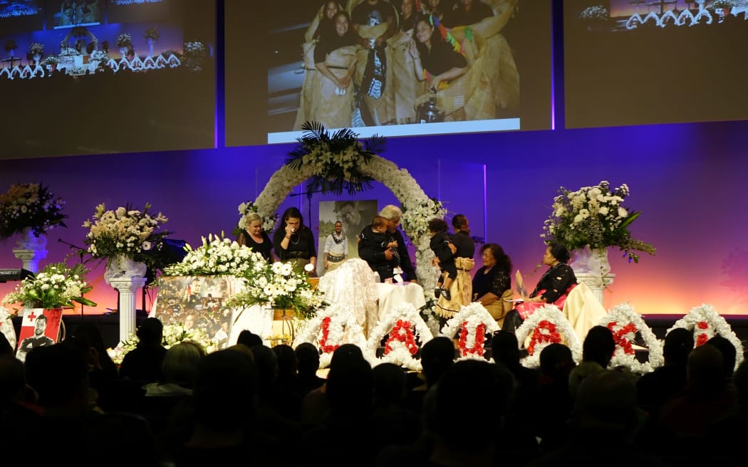 The family of Sione Lauaki, including wife Stephanie (second left), say their farewells.