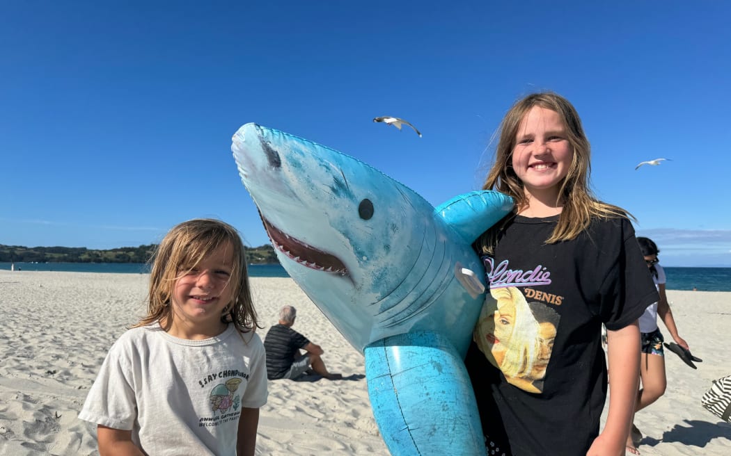 Vinnie and Winnie at Omaha Beach with their shark inflatable after a bronze whaler was spotted in the water on 3 January, 2024.