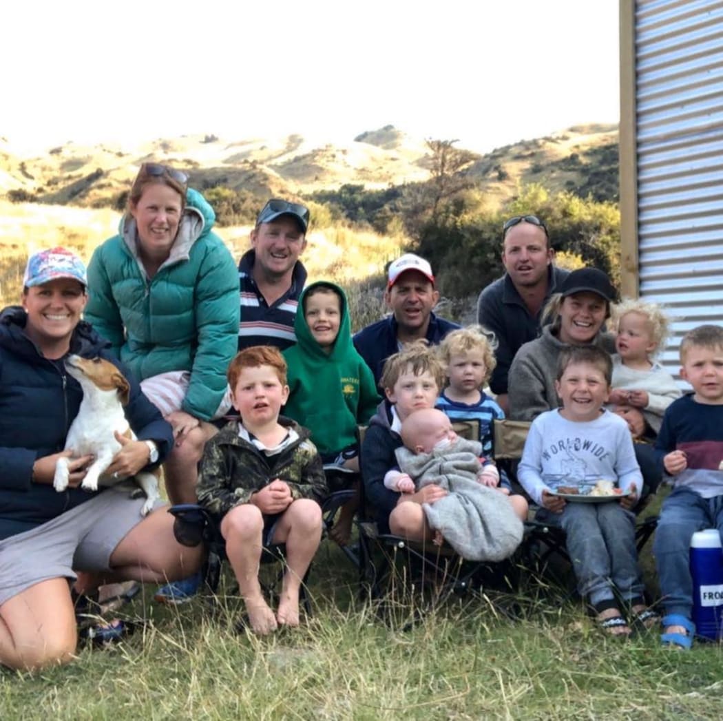 Rosie and Gavin Dowling, second and third from left, and Millie Volckman (third from right, in a cap), camping on the farm with their families over the new year.