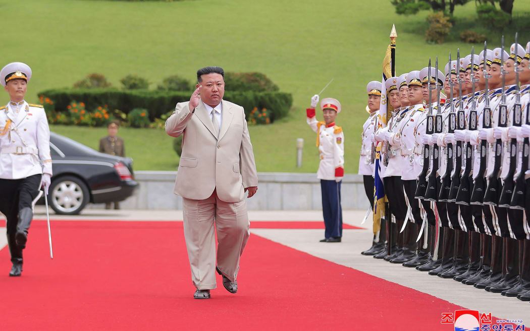 This picture taken on August 27, 2023 and released from North Korea's official Korean Central News Agency (KCNA) on August 29, 2023 shows North Korea's leader Kim Jong Un (C) saluting an honour guard as he visits the Naval Command of the Korean People's Army to mark Navy Day, at an undisclosed location in North Korea. (Photo by KCNA VIA KNS / AFP) / South Korea OUT / REPUBLIC OF KOREA OUT
---EDITORS NOTE--- RESTRICTED TO EDITORIAL USE - MANDATORY CREDIT "AFP PHOTO/KCNA VIA KNS" - NO MARKETING NO ADVERTISING CAMPAIGNS - DISTRIBUTED AS A SERVICE TO CLIENTS / THIS PICTURE WAS MADE AVAILABLE BY A THIRD PARTY. AFP CAN NOT INDEPENDENTLY VERIFY THE AUTHENTICITY, LOCATION, DATE AND CONTENT OF THIS IMAGE --- /