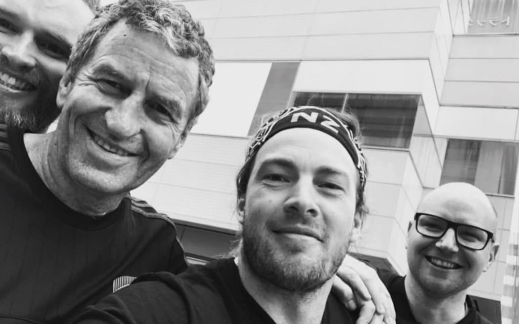Kim Boustridge (right), Andy Peat (left) and Adam John with NZ rugby union legend Wayne Smith at the 2019 World Cup.