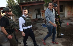 Far-right Israeli Finance Minister Bezalel Smotrich walks with soldiers during a visit to Kibbutz Kfar Aza near the border with the Gaza Strip on November 14, 2023, in the aftermath of an attack by Palestinian militants on October 7. More than 11,000 people have been killed in relentless Israeli bombardment of the Gaza Strip, according to the Hamas-run health ministry, since the war erupted after Palestinian militants raided southern Israel on October 7 killing at least 1200 people, according to official Israeli figures (Photo by GIL COHEN-MAGEN / AFP)