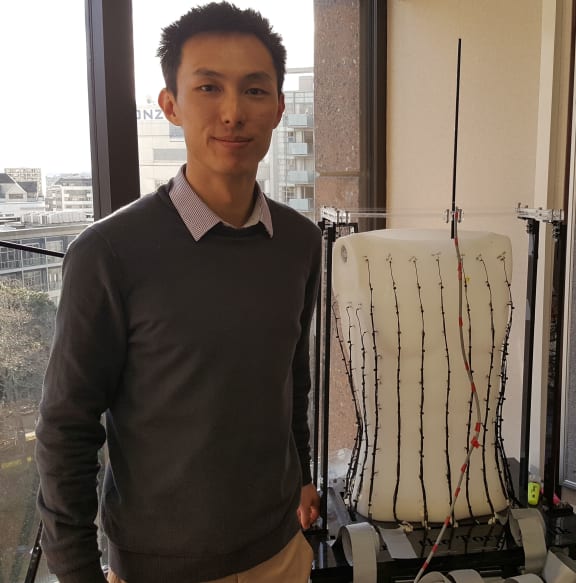 Peng Du with the 'torso tank' used to calibrate how electrical signals produced in the gut propagate across the body's surface.