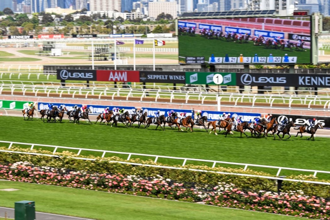 This handout photo taken and received from Racing Photos on November 3, 2020 shows the horses racing in front of empty grandstands in the Melbourne Cup at the Flemington Racecourse in Melbourne.